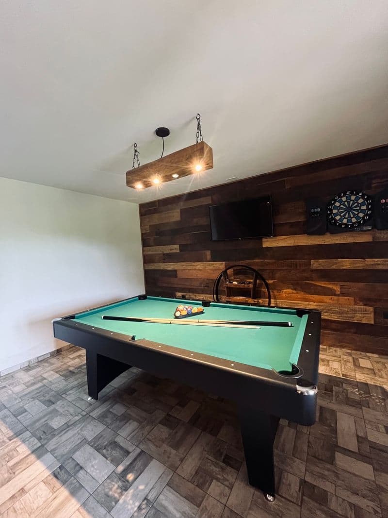 Games room with 8-ball pool table and dartboard