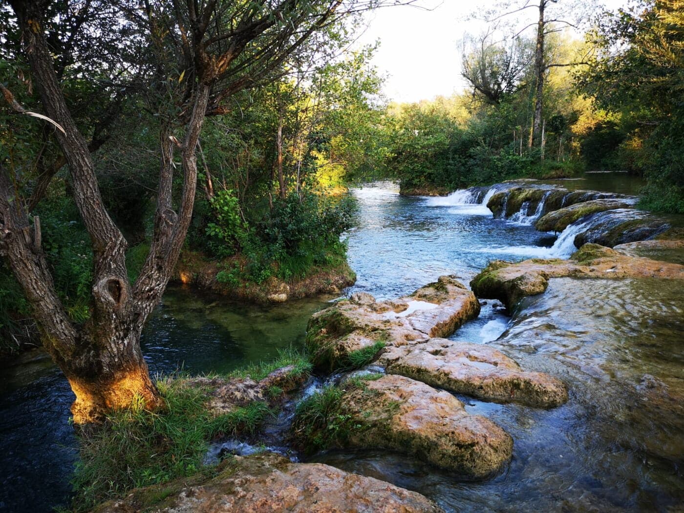 Golden-hour light over the crystal-clear Mrežnica waterfalls